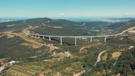 drone shot of viaduct črni kal with sea in the background