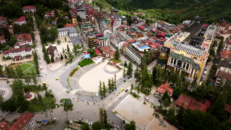 drone view of traffic flowing around sapa center in mountainous town, vietnam
