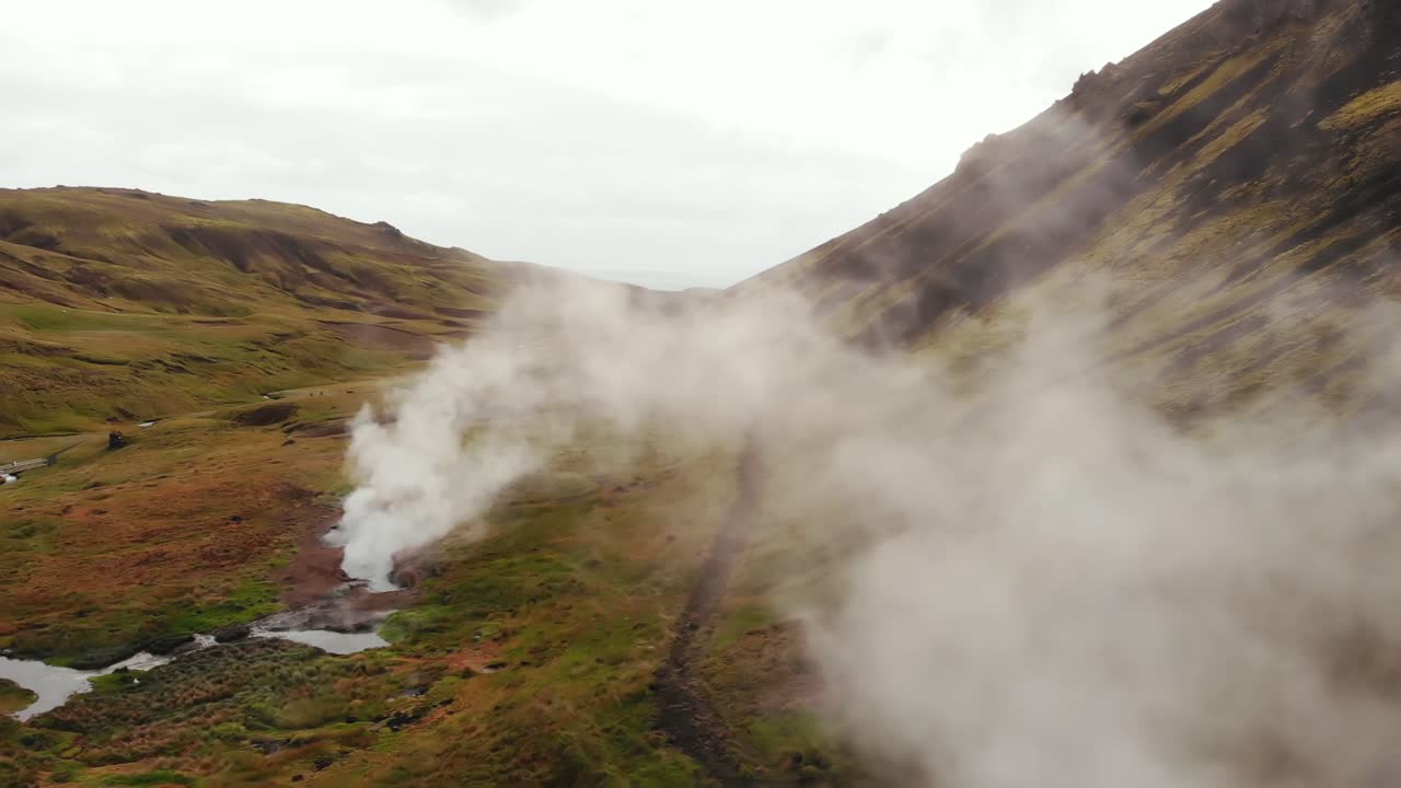 Drone flying through the steam of a geothermal hot spring in Hverager&eth;i, Iceland