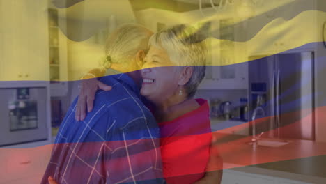 animación de la bandera de colombia sobre una pareja de ancianos afroamericanos abrazándose en la cocina