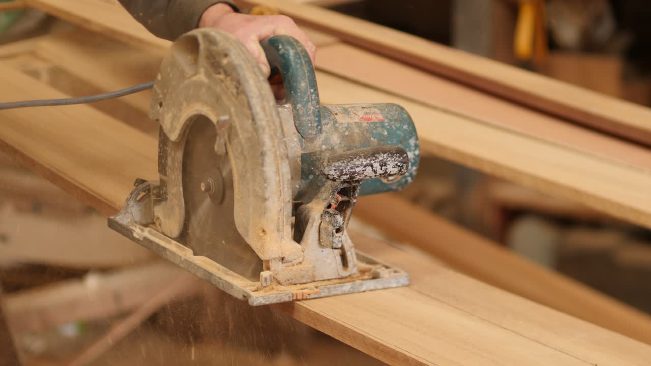 Circular Saw Cutting Plank, Lumber handheld shot