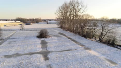 frozen river creeks in snowy winter landscape at sunset in herent, belgium