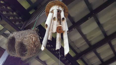 Cinematic-slow-pan-from-right-to-left-capturing-a-bamboo-wind-chime