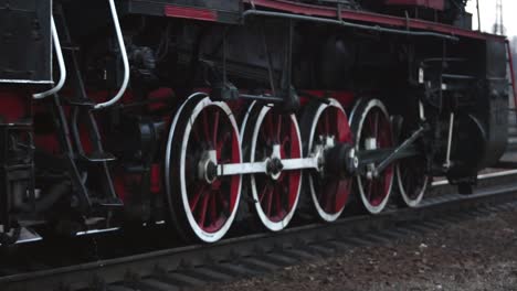 locomotive rolls along. grunge old steam diesel wheel and rods. steam