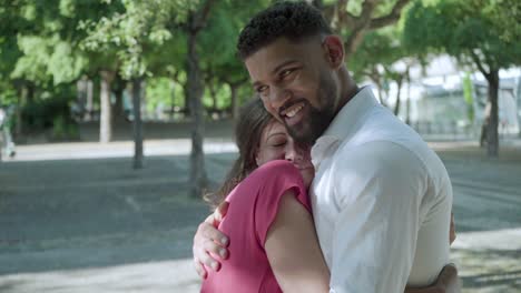 Happy-multiracial-couple-hugging-outdoor.