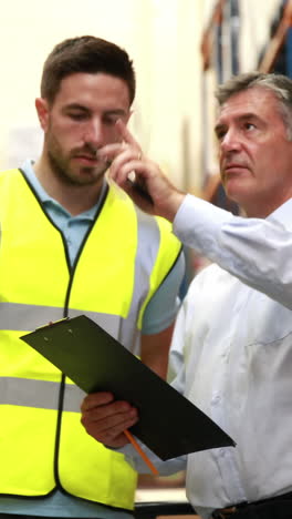 warehouse worker talking with his manager