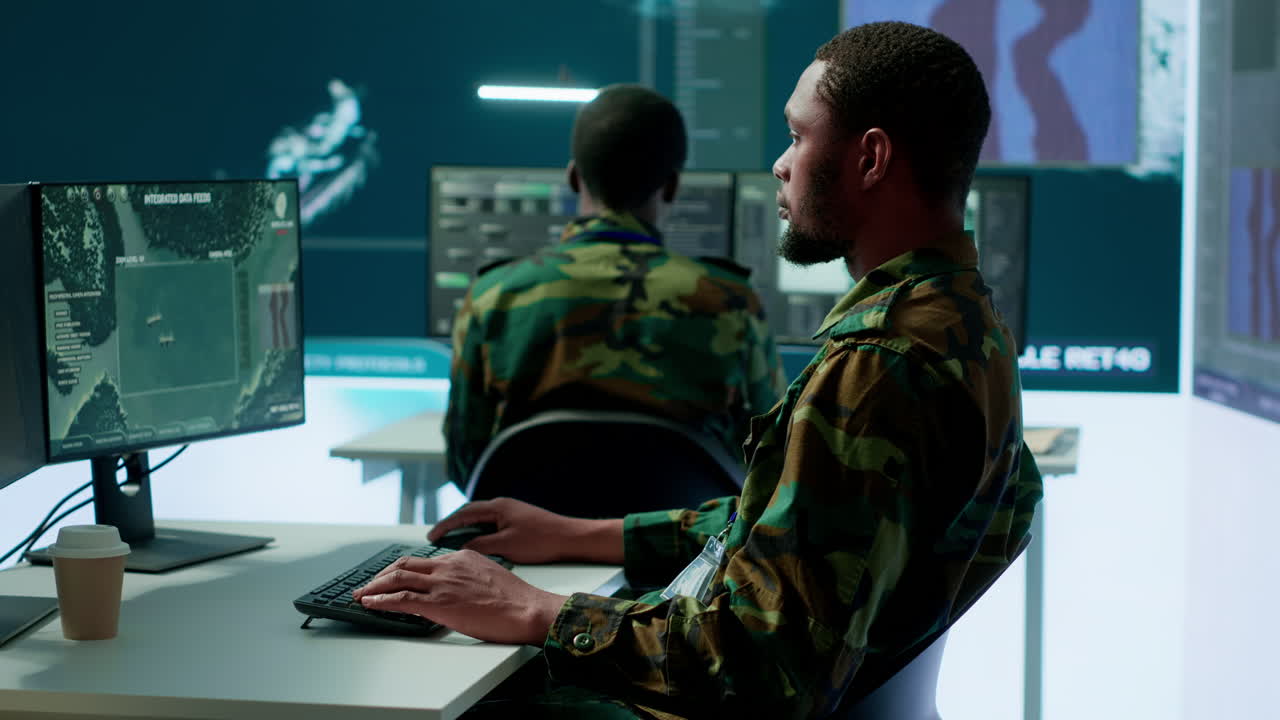 Military personnel in a high tech command center monitor satellite feeds