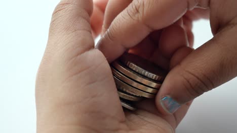 Child-hand-pick-coins-closeup-,