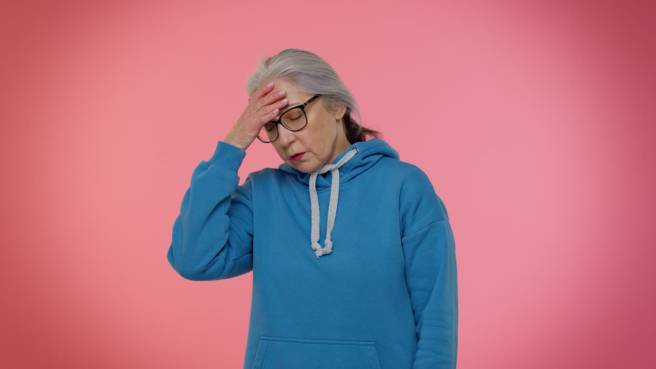 Lazy elderly woman yawning, sleepy inattentive feeling somnolent bored, suffering from lack of sleep