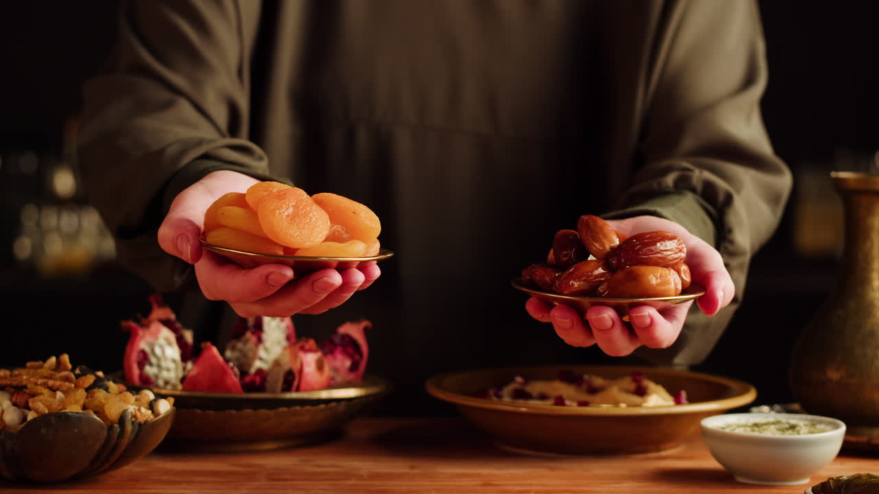 Person Holding Plates of Dried Dates and Apricots