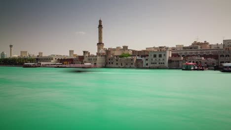 sunny day dubai city deira part bay roof top panorama 4k time lapse united arab emirates