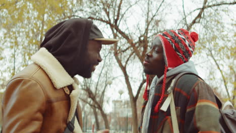 positive african american friends chatting in park