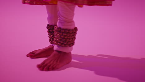 Close-Up-On-Feet-And-Bells-Of-Female-Kathak-Dancer-Performing-Dance-Wearing-Traditional-Indian-Dress-Against-Purple-Background-2