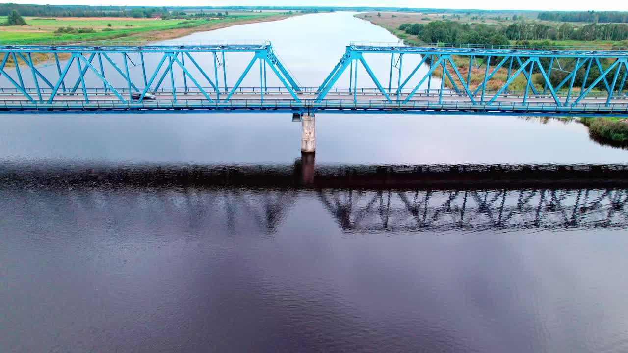 Stunning aerial view of a blue bridge over a river in Latvia
