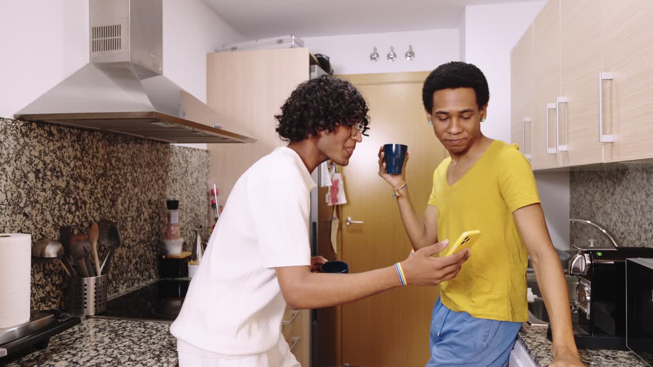 Two men having coffee in a kitchen