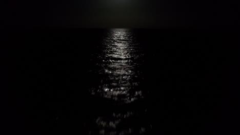 full moon moonlight over the atlantic ocean drone shot.