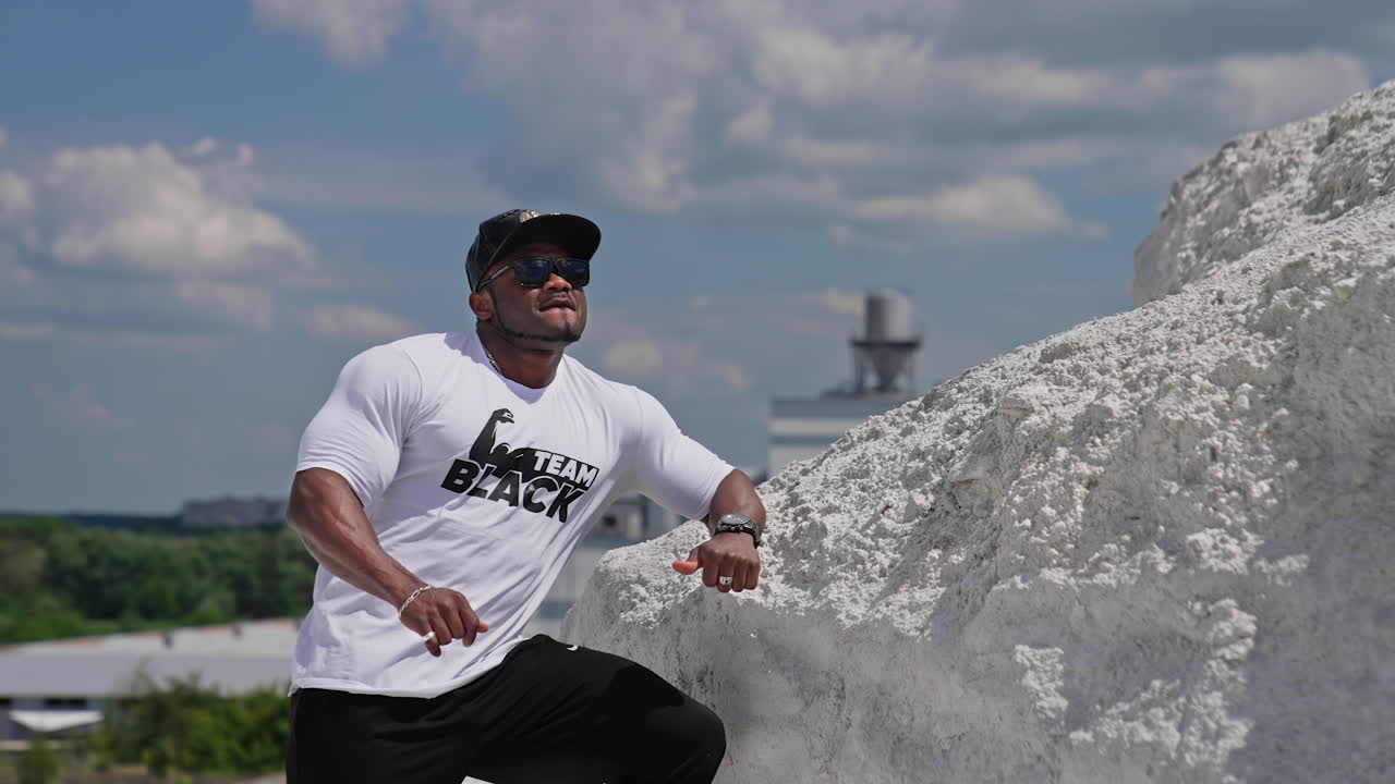 Athletic fitness model posing outdoor. Portrait of sporty handsome strong man outdoor