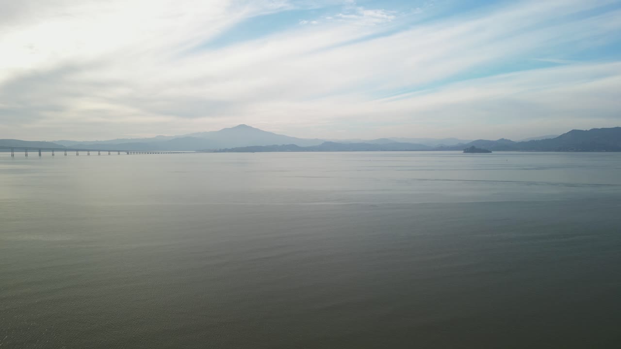 Soothing pullback over calm serene waters near Richmond Bridge from Point Molate Beach Richmond California USA