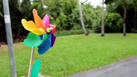 a vibrant pinwheel rotates outdoors on a breezy day.