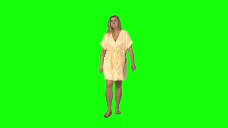 woman walking in yellow dress on green screen