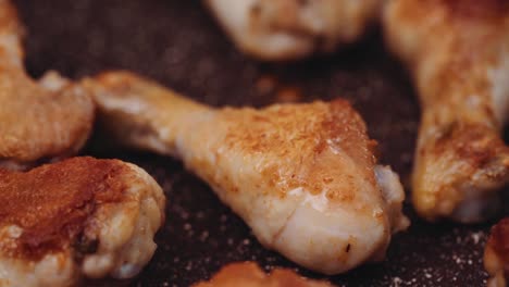 Turning-over-a-piece-of-chicken-leg-drumstick-being-fried-on-a-pan