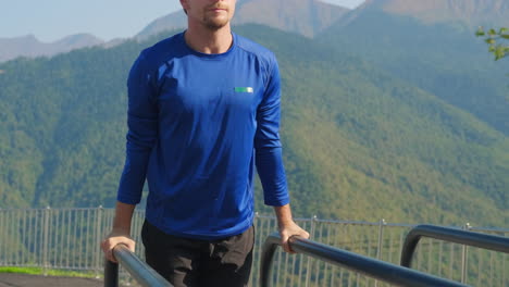 man doing push-ups outdoors in the mountains