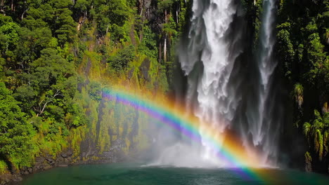 rainbow waterfall in lush forest