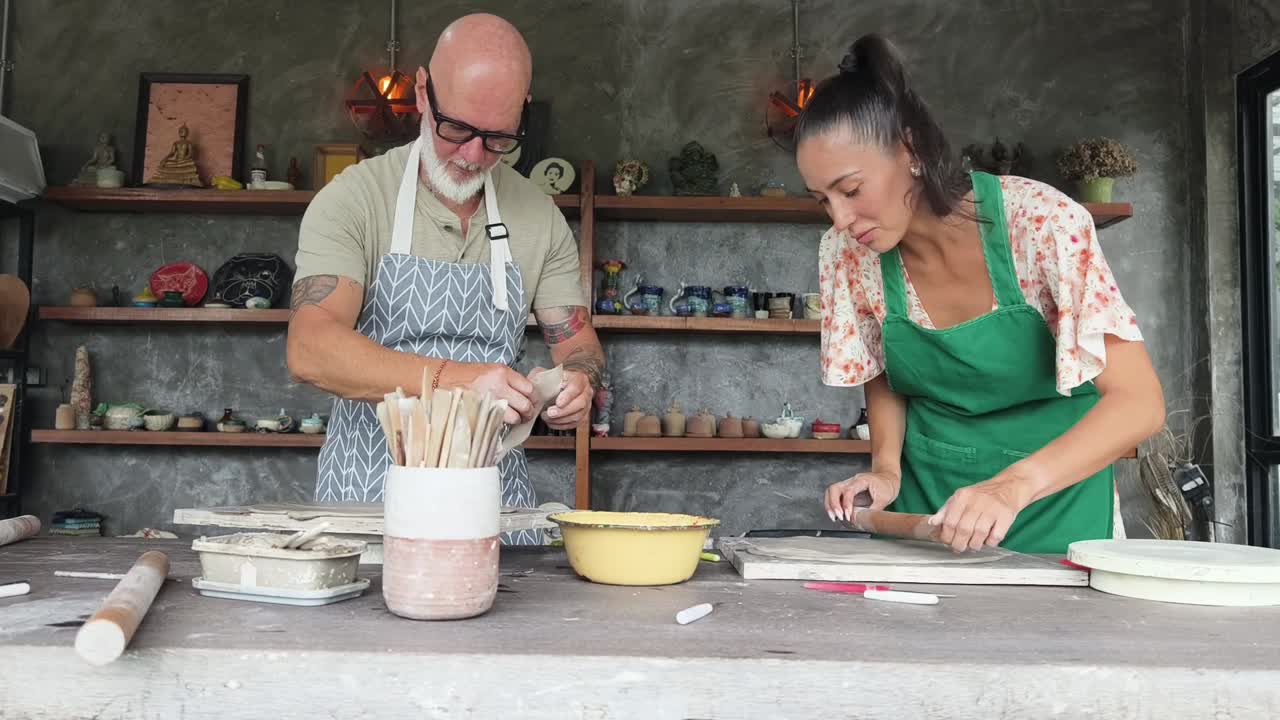 Man and Woman Working with Clay in Pottery Workshop