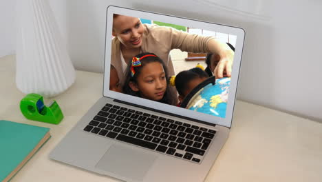 animation of a laptop showing multi-ethnic group of children and caucasian teacher