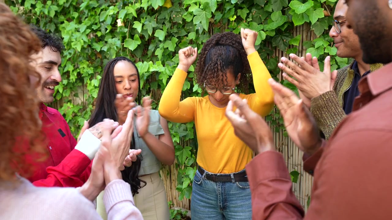 Diverse Group of Friends Celebrating and Clapping Together Outdoors
