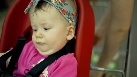 child sits in a specially equipped chair 10 in the supermarket 6