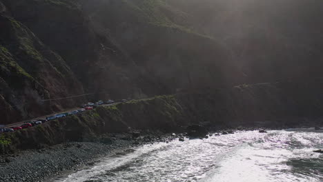 cars parked on the mountainous ocean coast of rural de anaga park,tenerife,spain.