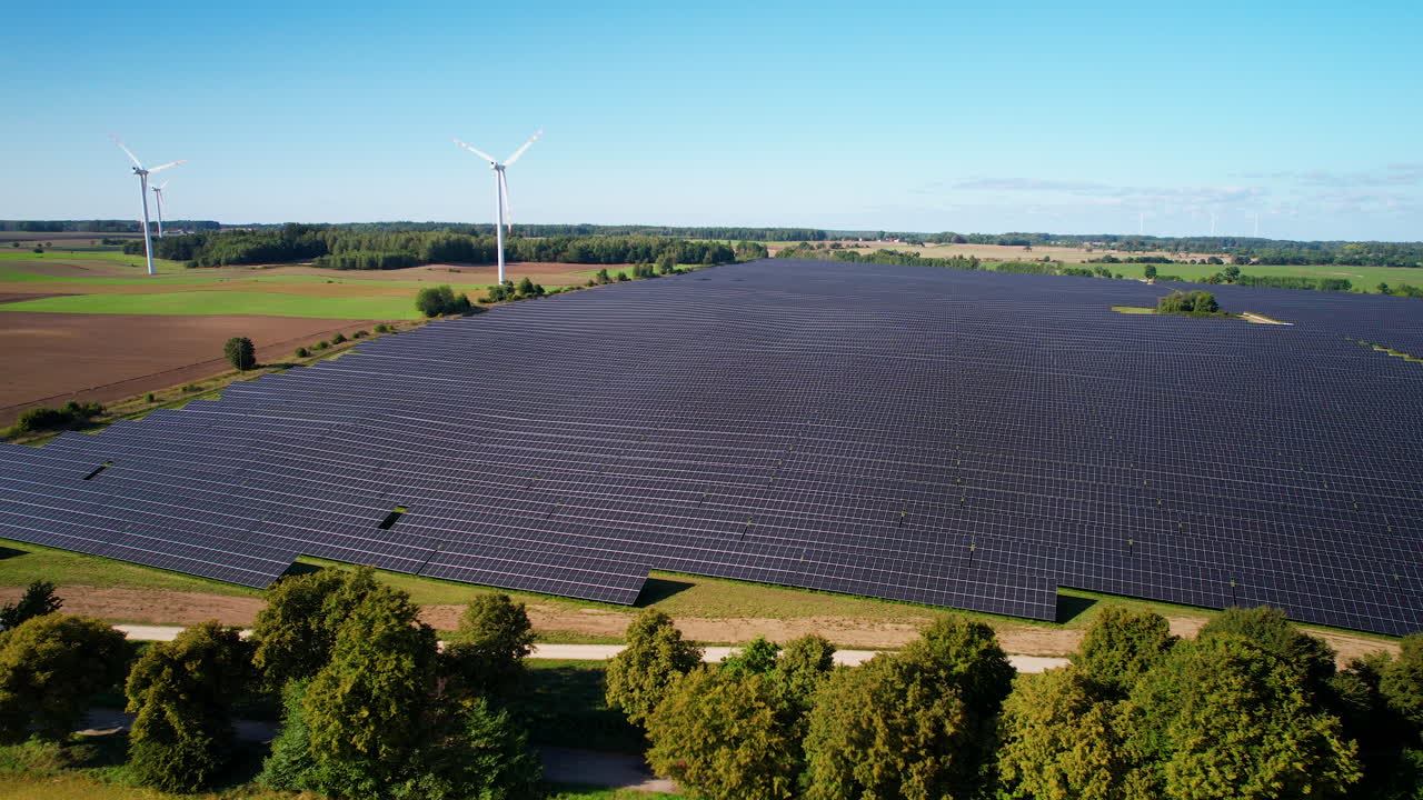 Vista Of Solar Park And Wind Turbine In A Rural Farm During Summer