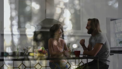 couple sitting at kitchen island, exploring health data with animated fruit bowl analytics overlay