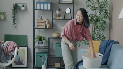 woman doing laundry in her living room