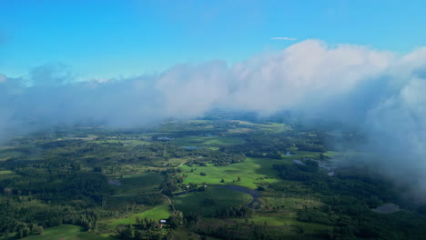 Green-vibrant-landscape-of-Latvia,-aerial-drone-view-from-cloudscape-level