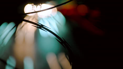 Abstract-Time-Lapse-of-Traffic-Headlights-on-a-Busy-Freeway-with-Barbed-Wire-in-the-Foreground