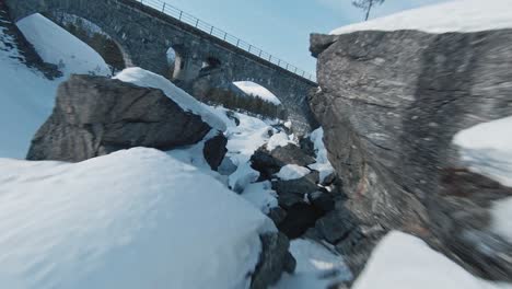 fpv drone flying under bridges in mountain region of norway