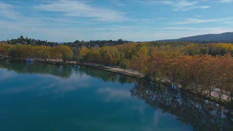 autumn at banyoles lake with blue mirror waters in girona, catalonia