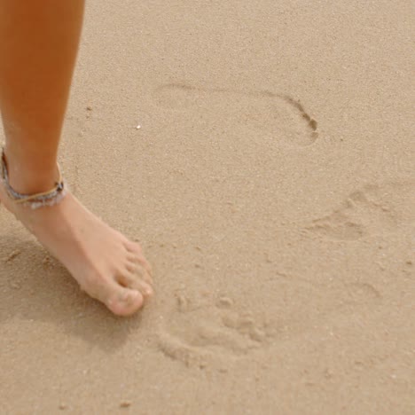 Bare-Feet-Coated-in-Sand-Walking-on-Beach