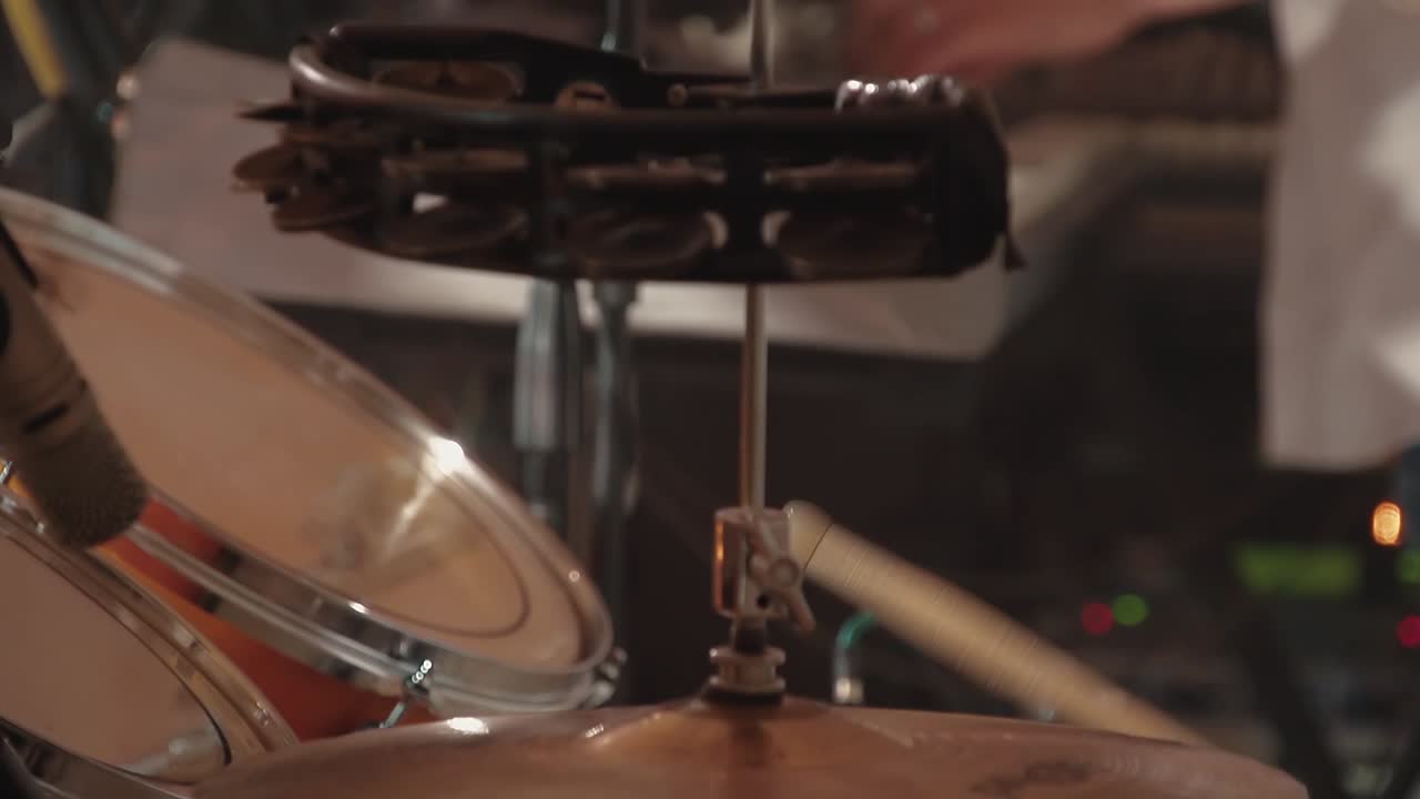 Drummer plays drums in the band at a concert