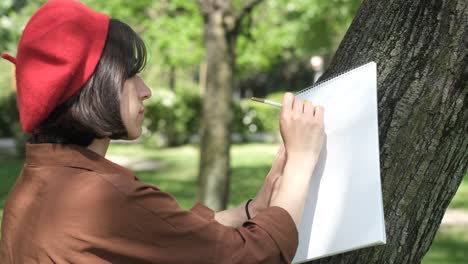 girl painting on tree