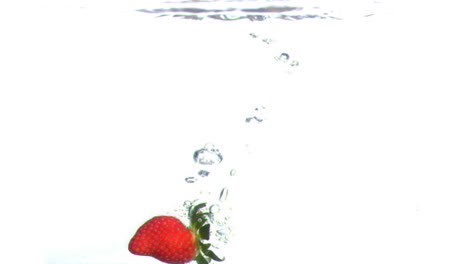 Strawberry-falling-into-water-in-super-slow-motion