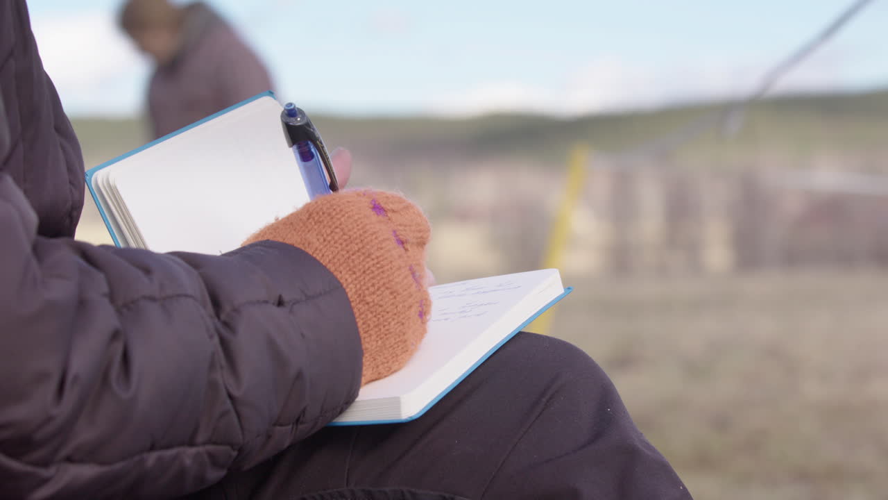 Woman writes in journal to process feelings during equine-facilitated workshop