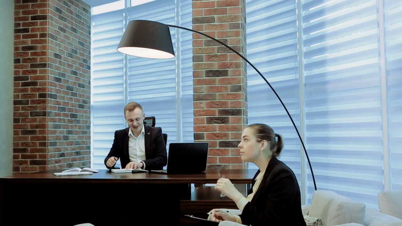 Business Woman Getting Direction From Her Boss. Business woman and man colleagues working in office