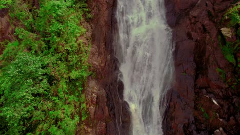 lush waterfall cascading down a rocky cliff in costa rica
