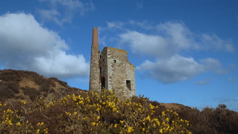 clouds cast shadows over old stone mine on hill in cornwall, uk