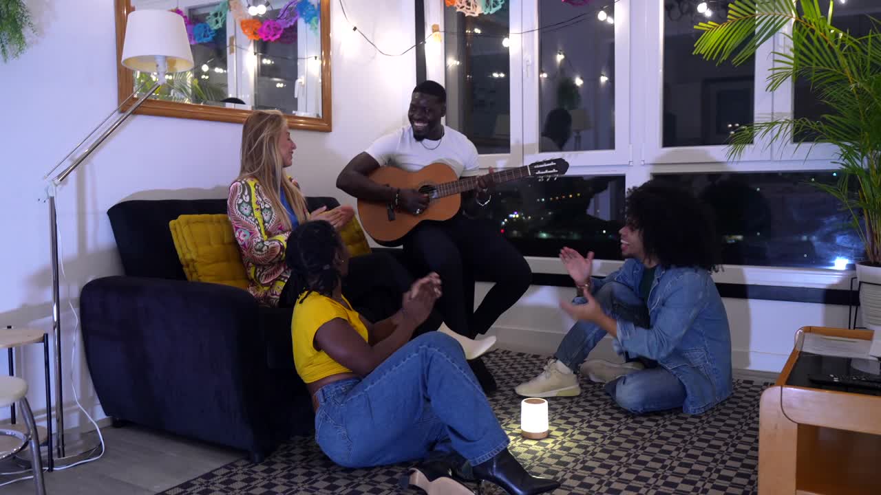 Group of friends enjoying music and social gathering indoors