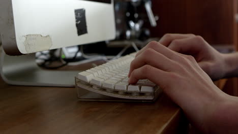 close up of teenage boy typing on computer keyboard on r3d