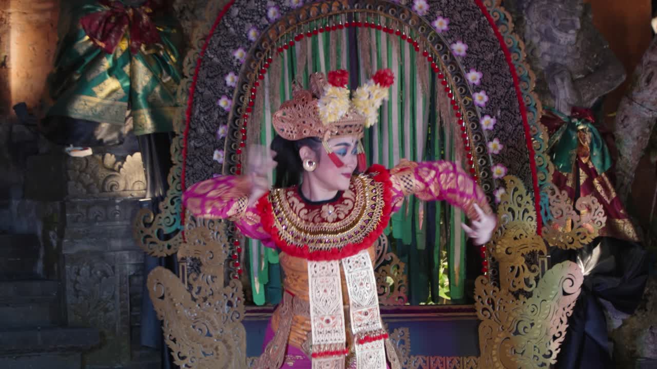 Woman Dancing Legong Dance Performance at Ubud Palace nighttime, Bali - close-up